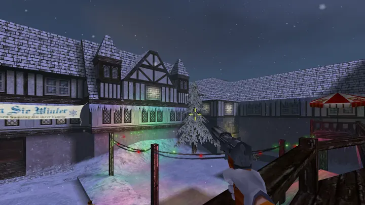 A snowy Alpine village square with a Christmas tree and fairy lights, seen over a pistol.